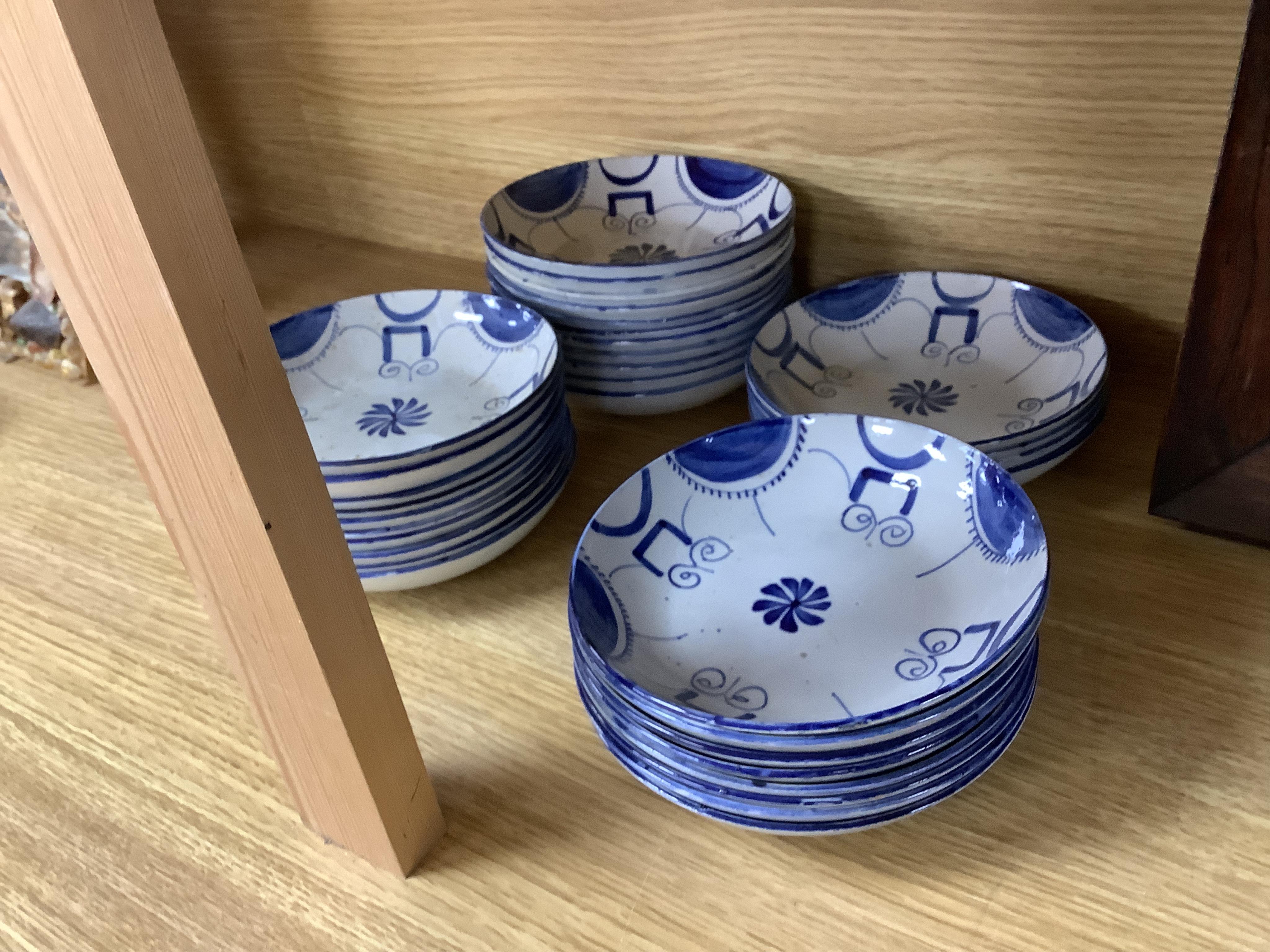 A group of 19th century pearlware set of tea bowls and saucers and to similar basket with border plates
